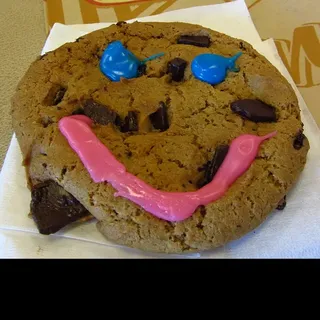 Tim Hortons Smile Cookie: a chocolate chunk cookie with a pink icing smile and blue icing eyes